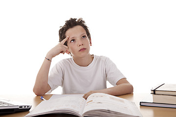 Image showing cute boy on the desk studying and thinking