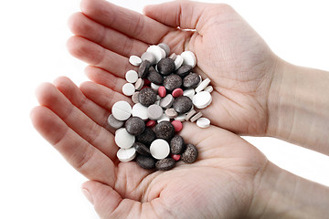 Image showing Hands with variety of pills