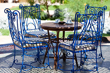 Image showing Table with chairs in the garden