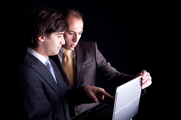 Image showing Two businessmen working together on a laptop