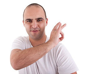 Image showing young man with a finger to remove something that is on the shoulder