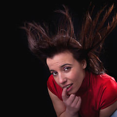 Image showing Beautiful young woman touching lips, with hair in the wind