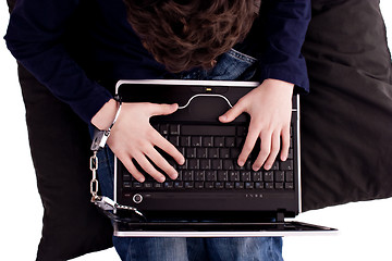 Image showing young man chained to the computer