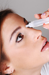 Image showing Woman with eyedrops.