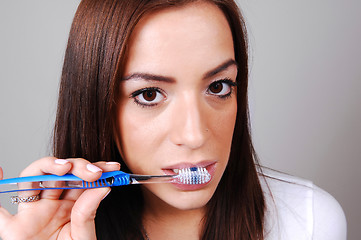 Image showing Woman brushing her teeth.