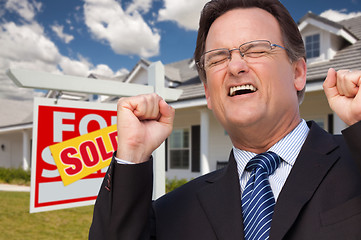 Image showing Excited Man in Front of Sold Real Estate Sign and House