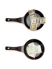 Image showing Two  frying pans with dollar and euro bills top view 