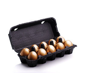 Image showing Gold eggs in a black carton