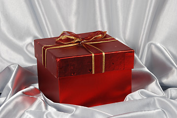 Image showing red gift box on white satin background