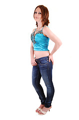 Image showing The young girl in jeans and blue top.