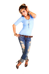 Image showing Young woman standing in ripped of jeans.