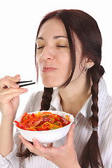 Image showing Beautiful woman eating with chopsticks