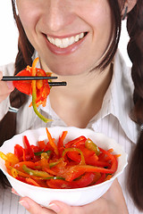 Image showing Beautiful woman eating with chopsticks