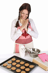 Image showing beautiful housewife with completed cakes