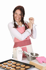 Image showing beautiful housewife with completed cakes