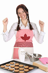 Image showing beautiful housewife with completed cakes