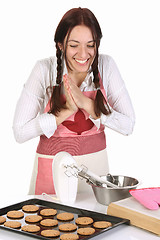 Image showing beautiful housewife with completed cakes