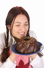 Image showing housewife smelling bundt cake