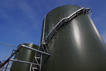 Image showing Low-angle shot of ladder and tanks refinery