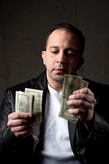 Image showing Man Counting His Money