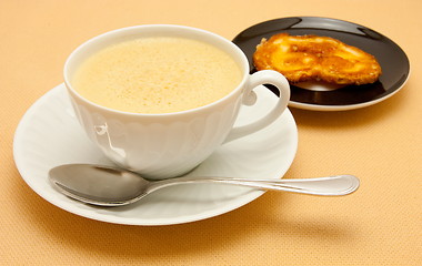 Image showing Closeup of coffee with milk in white cup and a palmier pastry