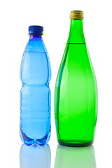 Image showing Bottles  of mineral water reflected on white background
