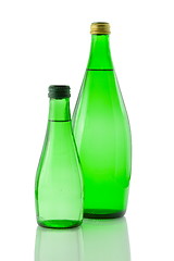 Image showing Bottles  of mineral water reflected on white background