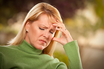 Image showing Grimacing Woman Suffering a Headache or Sorrow
