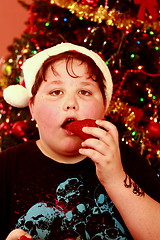 Image showing Young boy at Christmas with santa hat