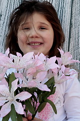 Image showing Little girl with bouquet of flowers