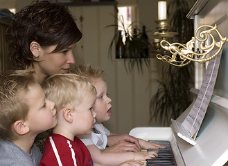 Image showing Family playing piano