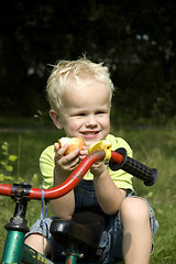 Image showing Boy eating an apple