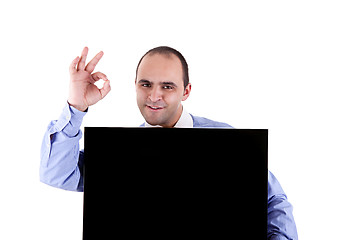 Image showing Young businessman holding a blackboard displaying the sign of success