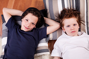 Image showing two boys lying on the floor