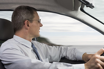 Image showing Businessman driving a car