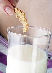 Image showing Young people eating milk with cereals