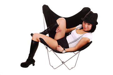 Image showing Asian girl lying in a butterfly chair.