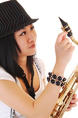 Image showing Chinese girl fixing the saxophone.