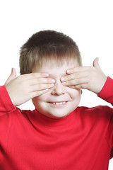 Image showing Smiling boy in red shutting eyes