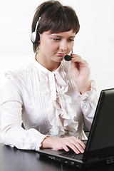 Image showing Businesswoman with headset working at computer
