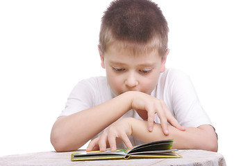 Image showing Boy reading book at table