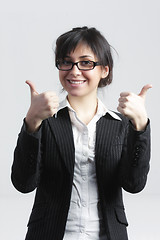 Image showing Smiling businesswoman raising thumbs up