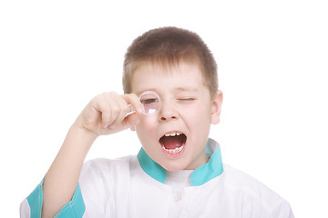 Image showing Boy looking through magnifying glass