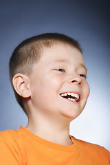 Image showing Laughing kid in orange shirt