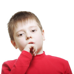 Image showing Serious boy in red leaning on fist
