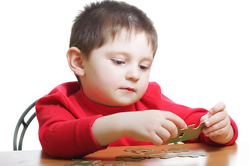 Image showing Boy assembling green puzzles