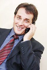 Image showing Smiling businessman with phone inclining left