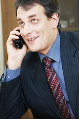 Image showing Positive businessman talking via phone