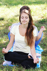 Image showing Young woman relaxing in yoga pose