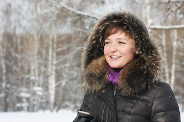 Image showing Smiling woman with phone in hand